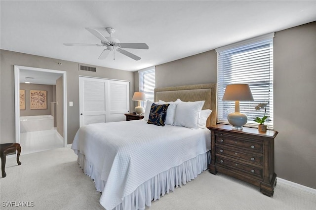 bedroom featuring visible vents, light carpet, a closet, baseboards, and ceiling fan