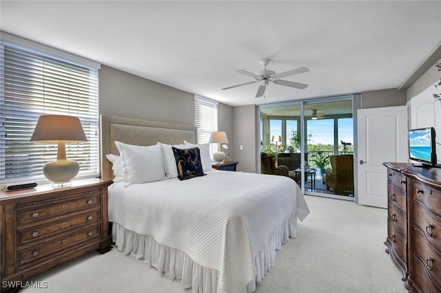 bedroom featuring a ceiling fan, access to exterior, multiple windows, and light colored carpet