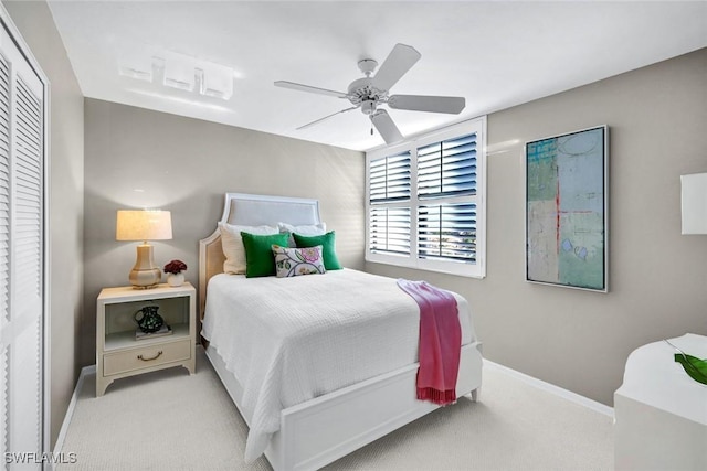 carpeted bedroom featuring a ceiling fan and baseboards