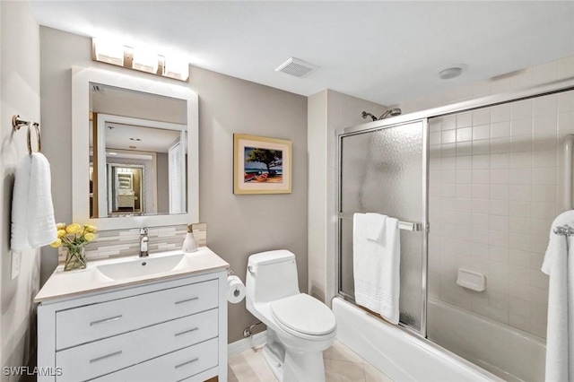 full bathroom featuring visible vents, toilet, tasteful backsplash, shower / bath combination with glass door, and vanity