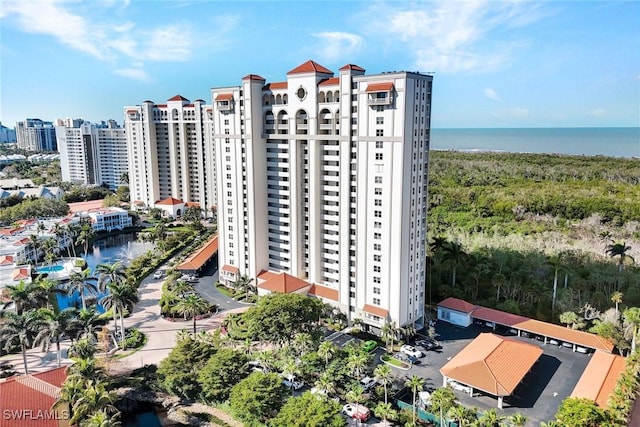 view of building exterior with a city view and a water view