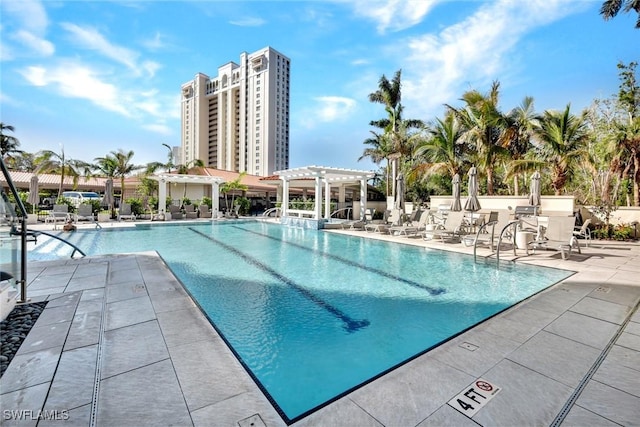 pool with a patio area and a pergola