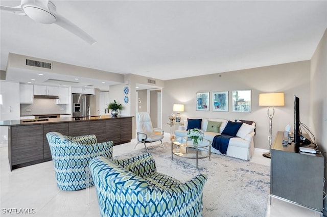 living room featuring visible vents, baseboards, and light tile patterned flooring