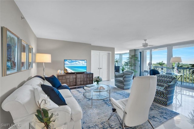 living room featuring floor to ceiling windows and a ceiling fan