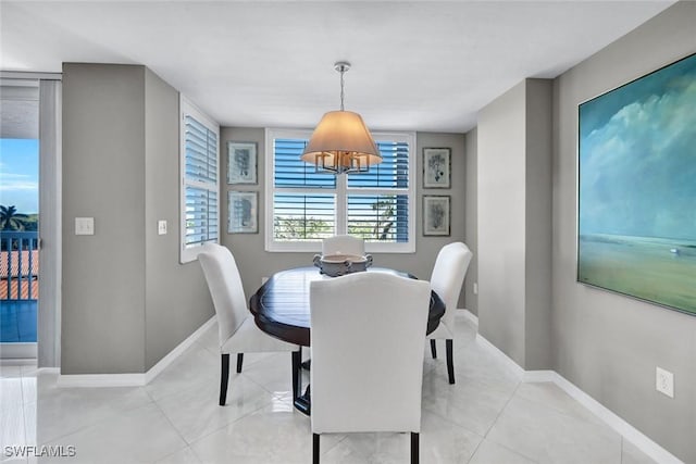 dining space with light tile patterned floors and baseboards