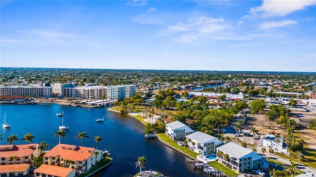 birds eye view of property with a water view and a view of city