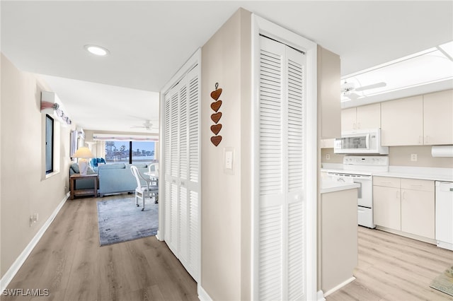 hallway with recessed lighting, baseboards, and light wood finished floors