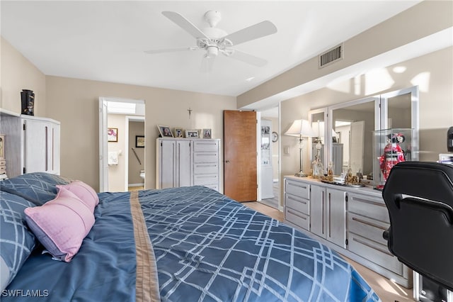 bedroom with visible vents, connected bathroom, and ceiling fan