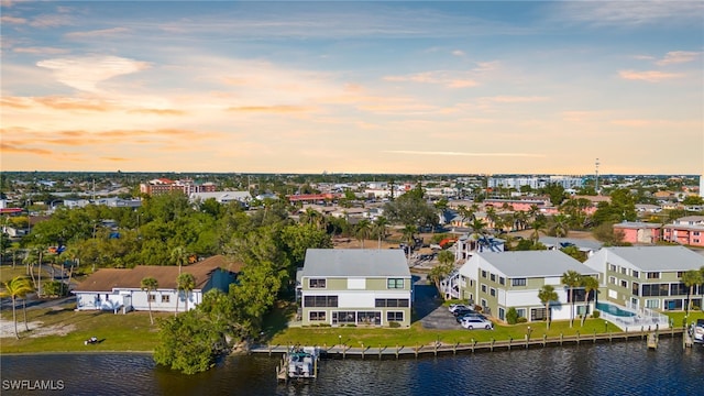 birds eye view of property with a water view and a residential view