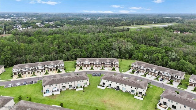 bird's eye view featuring a forest view and a residential view