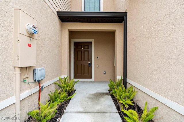 property entrance featuring stucco siding