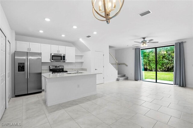 kitchen featuring visible vents, a sink, stainless steel appliances, light countertops, and open floor plan