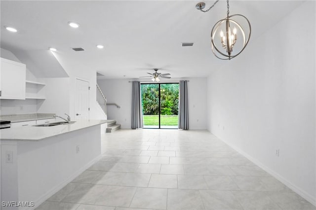 unfurnished living room featuring visible vents, baseboards, stairway, recessed lighting, and a sink