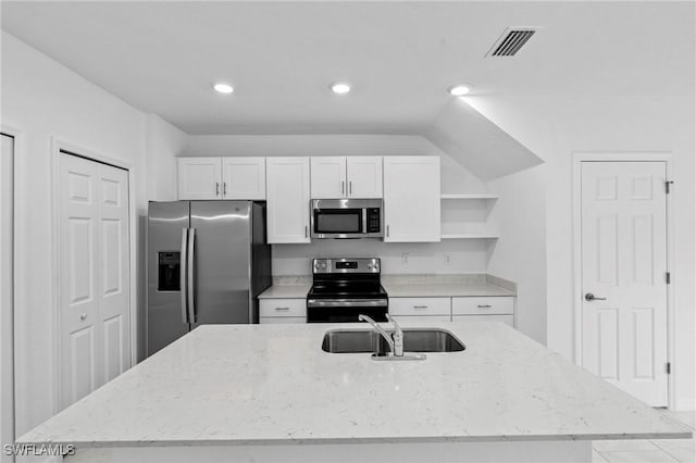 kitchen with open shelves, an island with sink, a sink, appliances with stainless steel finishes, and white cabinetry