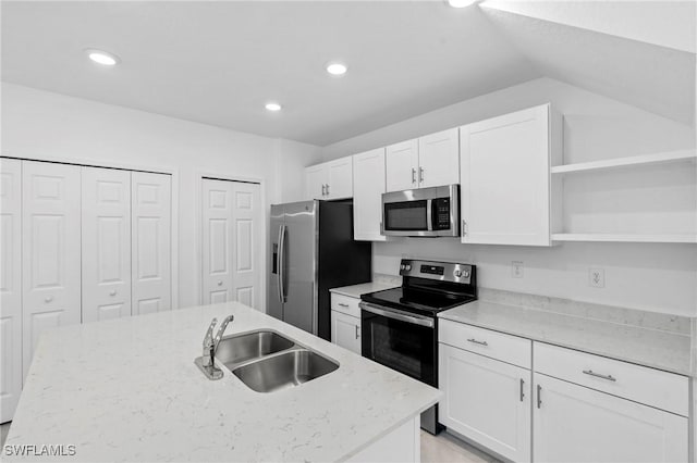 kitchen featuring a sink, open shelves, appliances with stainless steel finishes, and white cabinetry