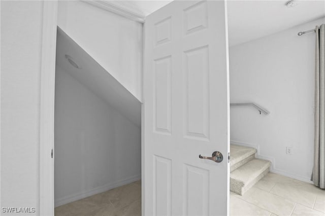 interior space featuring tile patterned floors and baseboards