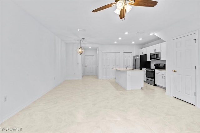 kitchen featuring an island with sink, recessed lighting, white cabinets, stainless steel appliances, and a sink