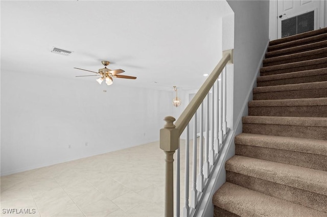 staircase with visible vents and ceiling fan