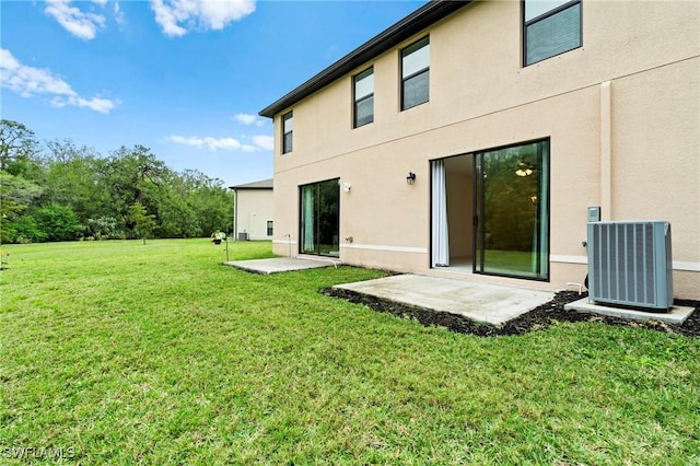 back of property featuring a patio area, stucco siding, cooling unit, and a lawn