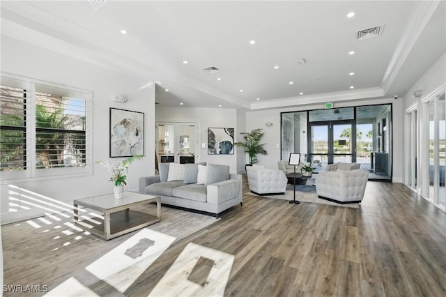 living room with visible vents, plenty of natural light, and french doors