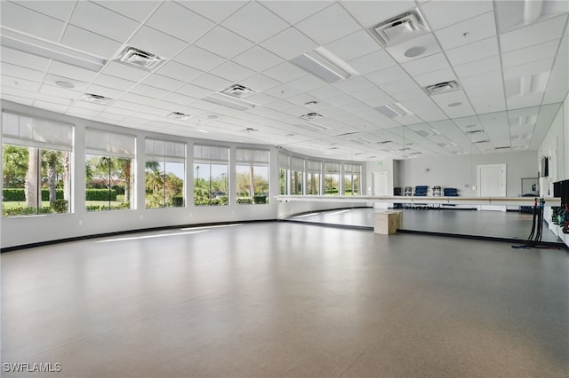 interior space featuring a healthy amount of sunlight, visible vents, and a paneled ceiling