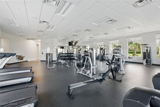 gym featuring a drop ceiling, visible vents, and baseboards