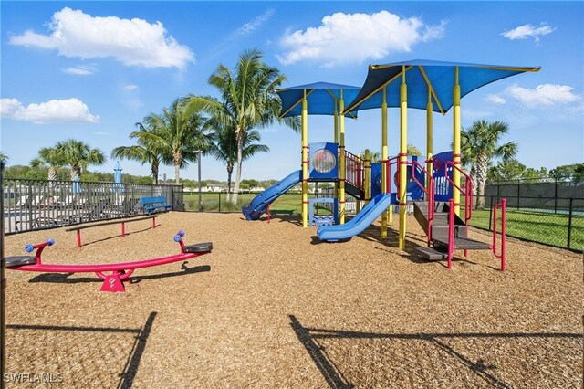 communal playground featuring fence