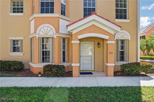 doorway to property with stucco siding