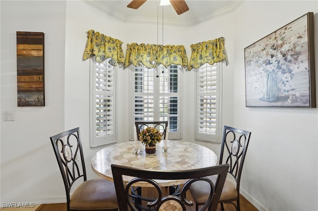 dining room with a ceiling fan, baseboards, and ornamental molding