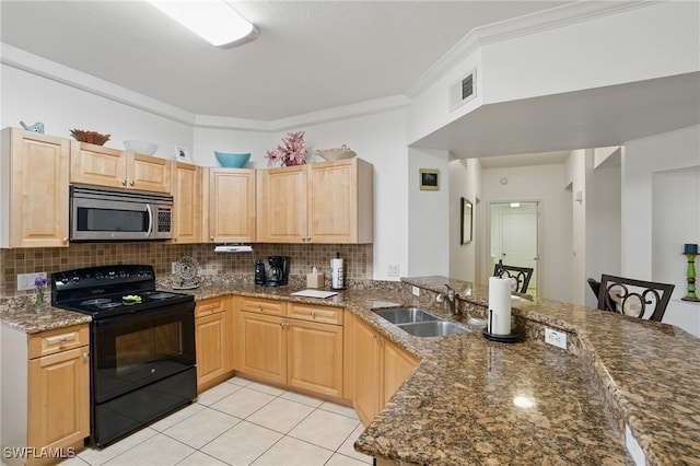 kitchen featuring a sink, stainless steel microwave, electric range, and light brown cabinets