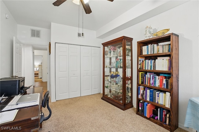 office area with carpet, visible vents, and ceiling fan