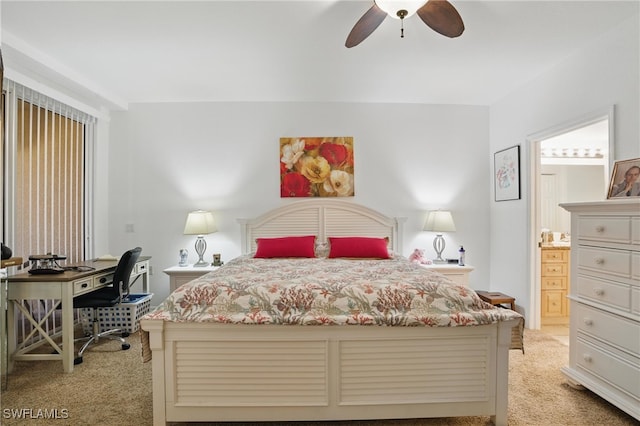 bedroom featuring light colored carpet, ensuite bath, and ceiling fan