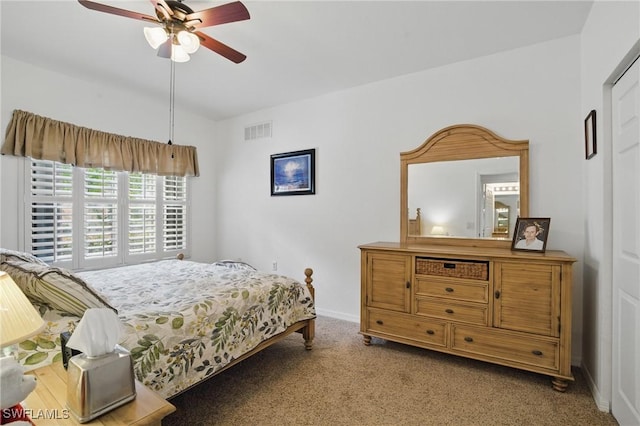 carpeted bedroom featuring visible vents, baseboards, a ceiling fan, and vaulted ceiling