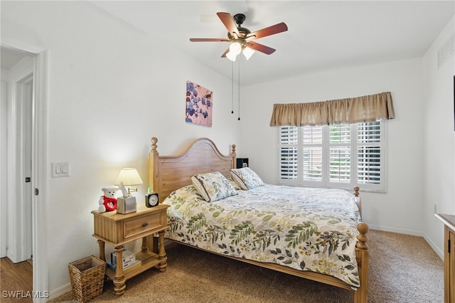 carpeted bedroom with a ceiling fan and baseboards