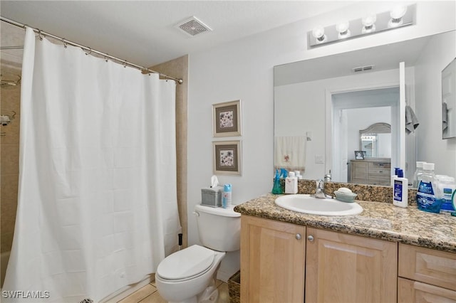 bathroom with vanity, toilet, a shower with curtain, and visible vents