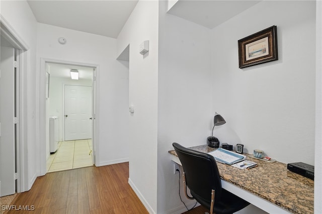 office area featuring baseboards and wood finished floors