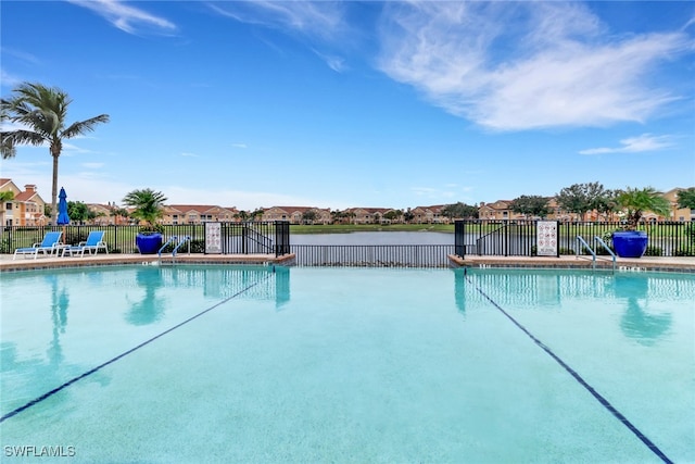 community pool with a residential view and fence