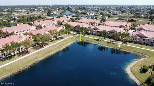 drone / aerial view featuring a residential view and a water view