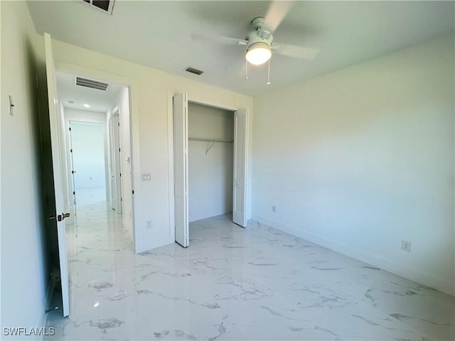 unfurnished bedroom with a closet, visible vents, marble finish floor, and baseboards