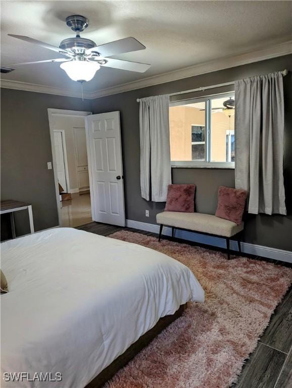 bedroom featuring visible vents, a ceiling fan, crown molding, and baseboards