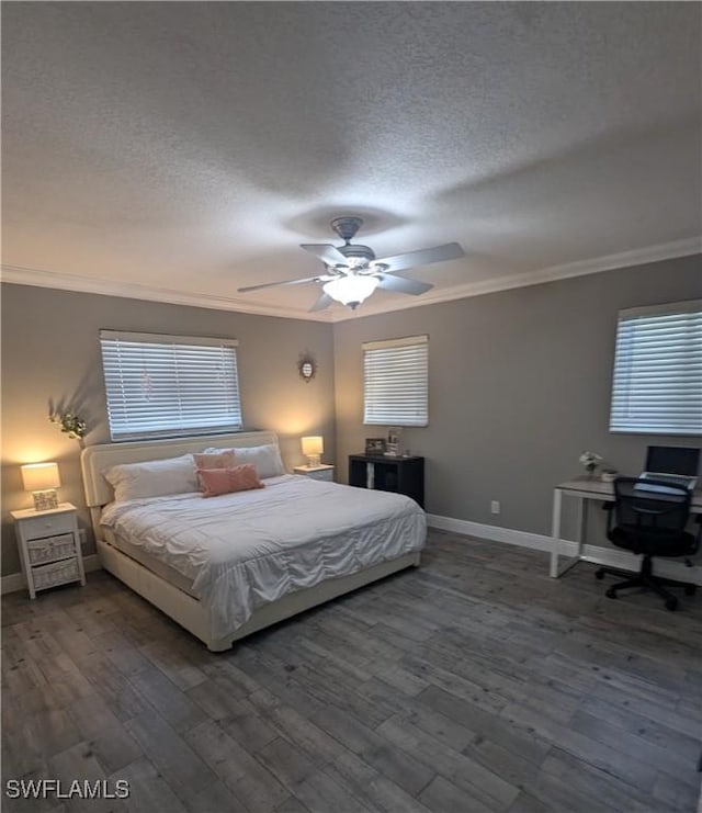 bedroom with a textured ceiling, crown molding, baseboards, and wood finished floors