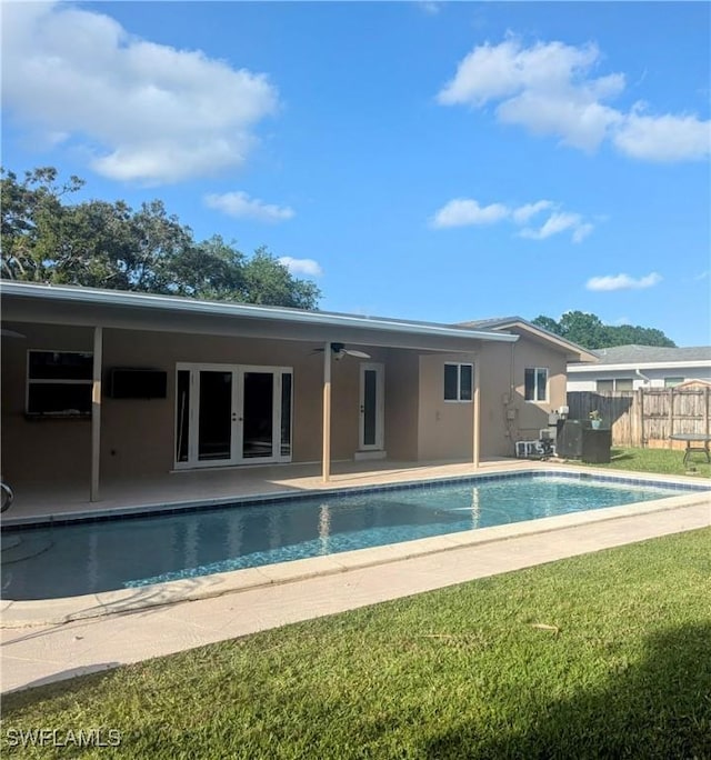 back of house featuring a fenced in pool, fence, stucco siding, french doors, and a patio area