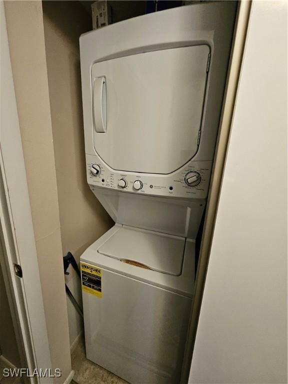 laundry area with stacked washer and dryer