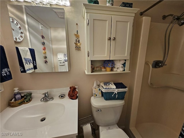 bathroom with vanity, toilet, and a walk in shower