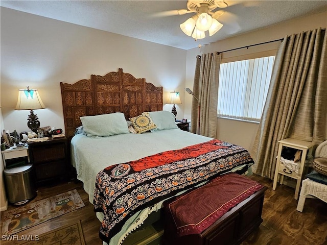 bedroom with dark wood-style floors and a ceiling fan