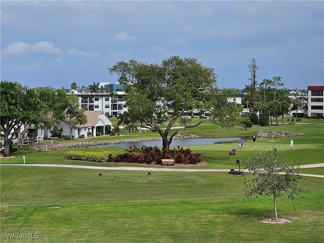 view of home's community featuring a lawn and a water view