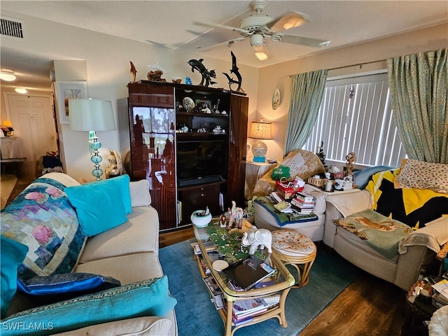 living room with a ceiling fan, wood finished floors, and visible vents