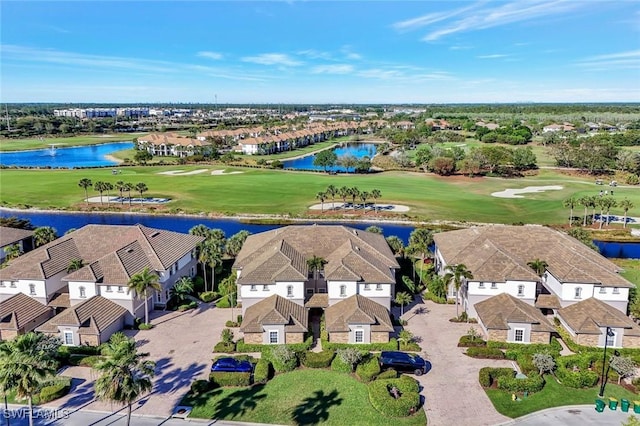 birds eye view of property with a residential view, a water view, and view of golf course