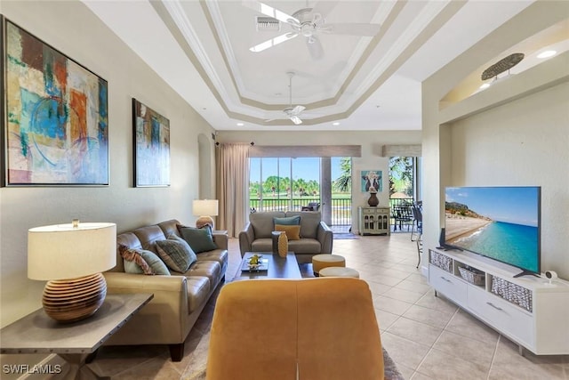 living area featuring visible vents, ornamental molding, a ceiling fan, light tile patterned floors, and a raised ceiling