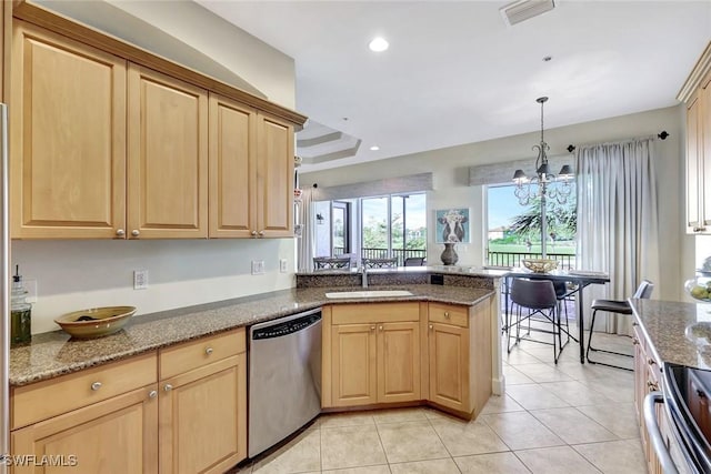 kitchen featuring visible vents, a peninsula, light brown cabinetry, a sink, and dishwasher